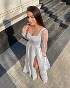 Rochie de mireasa alba lunga din satin eleganta cu slit si maneci transparente.